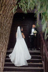 couple in love. stylish Groom in a wedding suit and the bride in a chic white dress. Wedding ceremony.