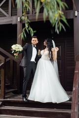 couple in love. stylish Groom in a wedding suit and the bride in a chic white dress. Wedding ceremony.