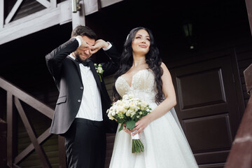 couple in love. stylish Groom in a wedding suit and the bride in a chic white dress. Wedding ceremony.