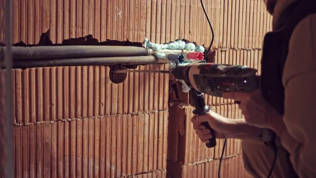 Drilling a Hole with a perforator on the Wall for Construction or Renovation