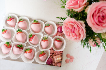 Pink chocolate covered strawberries with roses and pink chocolate buttons from above