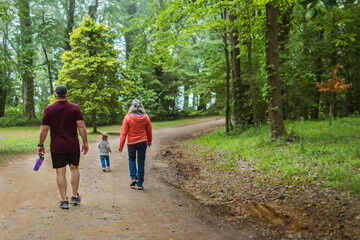 Fototapeta premium parent and child walking in the park