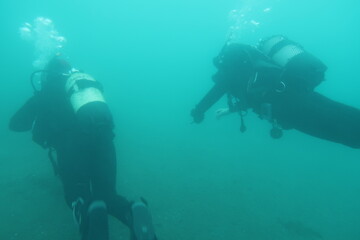 Fototapeta na wymiar Two scuba divers in the sea