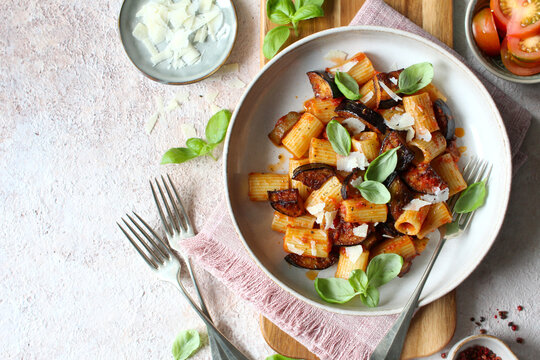 Pasta alla norma - Italian pasta with eggplant, tomato sauce and parmesan cheese. Top view.