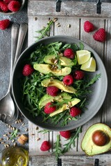 Avocado salad with arugula, raspberries and sunflower seeds. Top view. Healthy food.