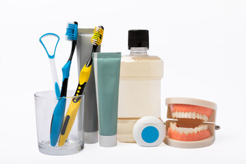 Dental care. Mouthwash bottle, toothbrush and paste, tongue cleaner, dental floss isolated on white...