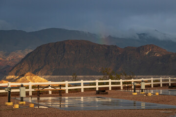 Camping spot with rainclouds and rainbow over Lake Mead National Recreation Area, Nevada