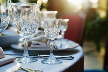 empty wine glasses on the table.table setting for a festive dinner. solar glare.