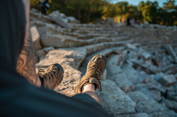 Man Sitting on Steps in Ancient Amphitheater