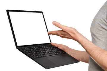 A man in a T-shirt holds a laptop, an ultrabook and points to the screen with his hand.