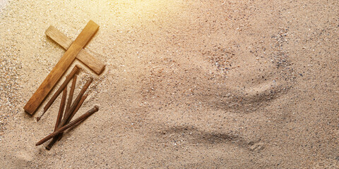 Banner with wooden cross and nails on sand. Good Friday concept