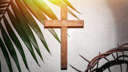 Plakat Crown of thorns with wooden cross and palm leaf on light background. Good Friday concept