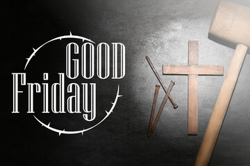 Wooden cross, nails, mallet and text GOOD FRIDAY on dark background