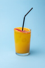 Cocktail on a blue background. Alcohol, party, drink in a beautiful glass.