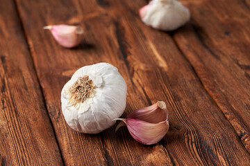 Garlic on the brown wooden table.