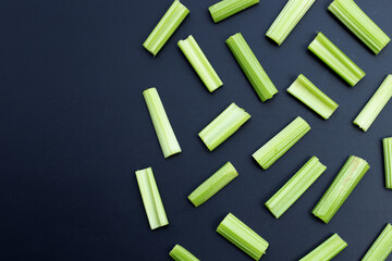 Fresh celery on dark background. Top view