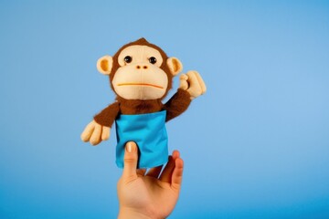 Soft puppet toy on hand on blue background. AI generated, human enhanced