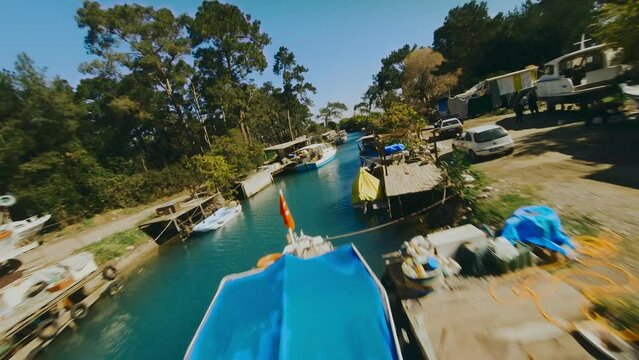 boats are moored in a narrow channel. Dynamic flight on fpv drone