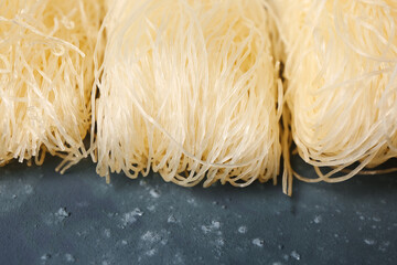 Raw rice noodles on dark background, closeup