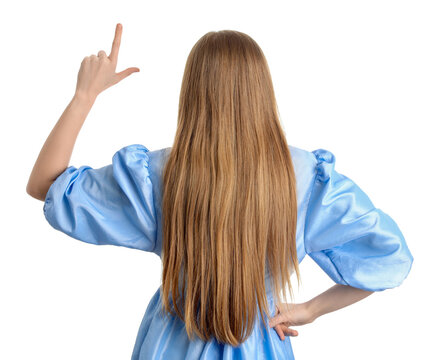 Young woman in dress showing loser gesture on white background, back view