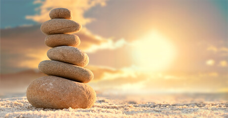 Fototapeta na wymiar Stone tower. Natural pebble stone on the beach. Balancing body, mind, soul and spirit. Mental health.
