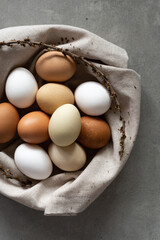 Minimalist Easter eggs. Nature colors eggs on a gray background. A chicken egg as a valuable...