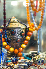 Close up of counter with silver, amber jewelry and necklaces  with ornaments from Turkey. Oriental...