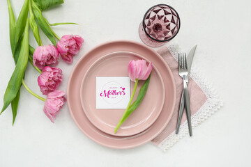 Stylish table setting with beautiful tulip flowers for Mother's Day celebration on light background