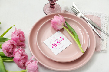 Stylish table setting with beautiful tulip flowers for Mother's Day celebration on light background