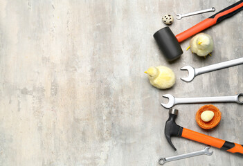 Handyman's tools with chickens and Easter eggs on grunge background