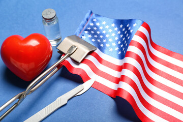Surgical tools with heart and USA flag on blue background, closeup