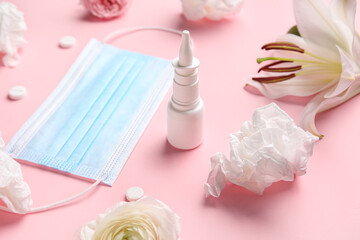 Nasal drops with pills, flowers, medical mask and tissues on pink background, closeup. Seasonal allergy concept