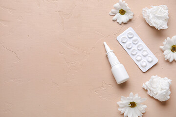 Nasal drops with pills, flowers and tissues on beige background. Seasonal allergy concept