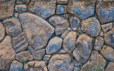 Orange, Tan, and Blue Toned Pumice and Lava Rock Wall in Hawaii.