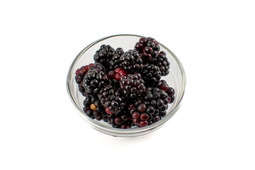 Glass prep bowl full of ripe juicy blackberries