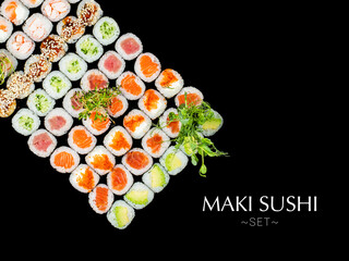 Variety of Japanese Maki sushi roll pieces isolated on black background. Large set with salmon, tuna, shrimp, avocado, cucumber with micro greens on top. Ready banner concept with text, copy space