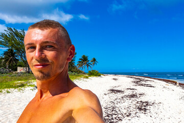 Male tourist traveler at tropical beach Playa del Carmen Mexico.