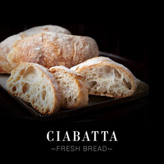 Close up to traditional Italian Ciabatta isolated on black background. Ready square menu banner with text and copy space. Fresh whole wheat durum bread served on plate