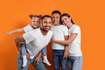 Happy international family with children on orange background