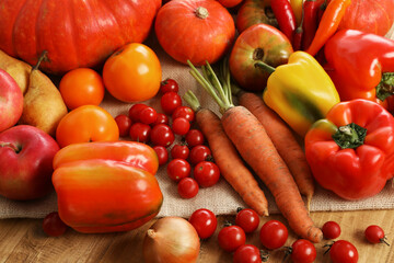 Different fresh ripe vegetables and fruits on wooden table, closeup