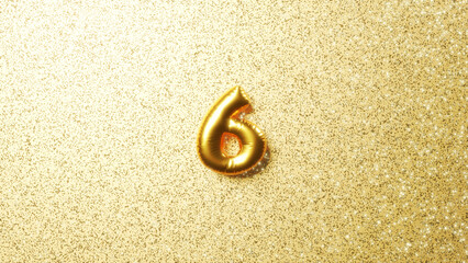 Fototapeta na wymiar キラキラした金色の背景に立体的な数字の6。金色のバルーン、風船の数字。