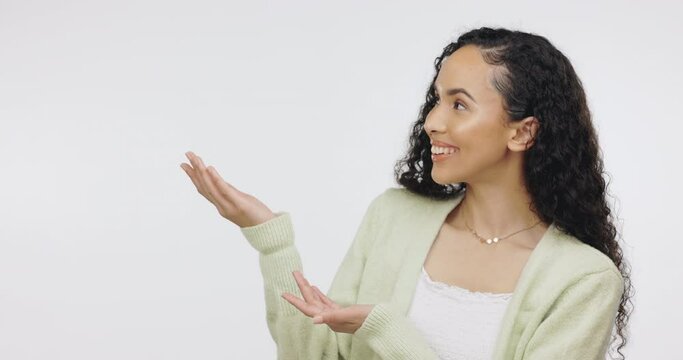 Advertising, marketing or mockup with a black woman in studio on a gray background to introduce a product. Presentation, branding or portrait with an attractive young female making an announcement