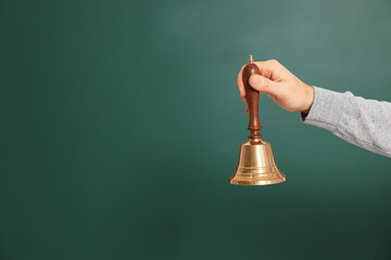 Teacher with school bell near chalkboard, closeup. Space for text - obrazy, fototapety, plakaty