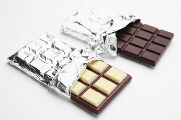 Two tasty chocolate bars on white background