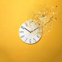 Fleeting time concept. Analog clock dissolving on yellow background