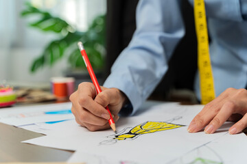 The tailor is working at his best.sketch clothes with laptop computer design to customer,occupation...