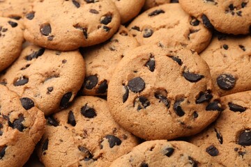 Delicious chocolate chip cookies as background, closeup