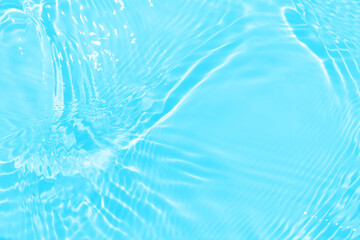 Defocus blurred transparent blue colored clear calm water surface texture with splashes and bubbles. Trendy abstract nature background. Water waves in sunlight with copy space. Blue watercolor shining