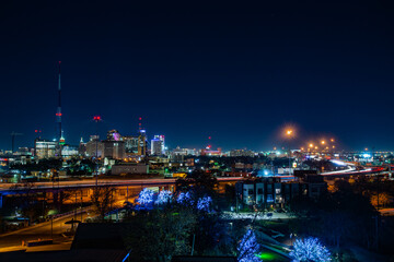 Fototapeta na wymiar Skyline of San Antonio, Texas USA at night, as seen from the Cellars apartments at The Pearl.