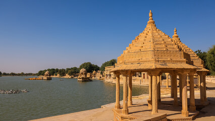 Artistically carved sandstone pavilions at the Lake Gadisar in Jaisalmer, Rajasthan, India.